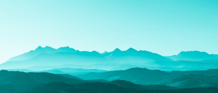 Green surreal mountains against the backdrop of a turquoise sky, fantastic fairytale mountain landscape
